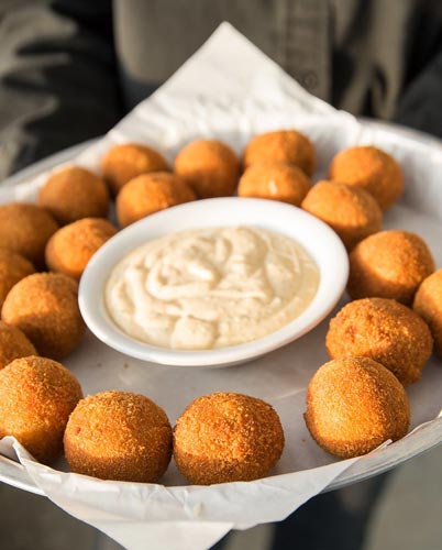 Sam’s Chowder House offsite catering menu includes fresh hush puppies with dipping sauce for passing