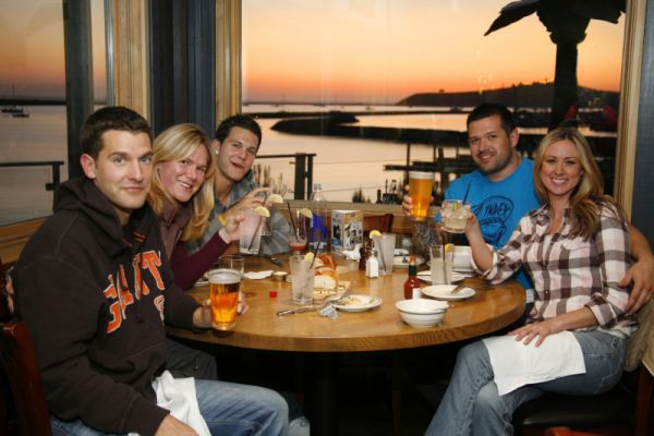 private party enjoys ocean view sunset from Mavericks Room at Sam's Chowder House